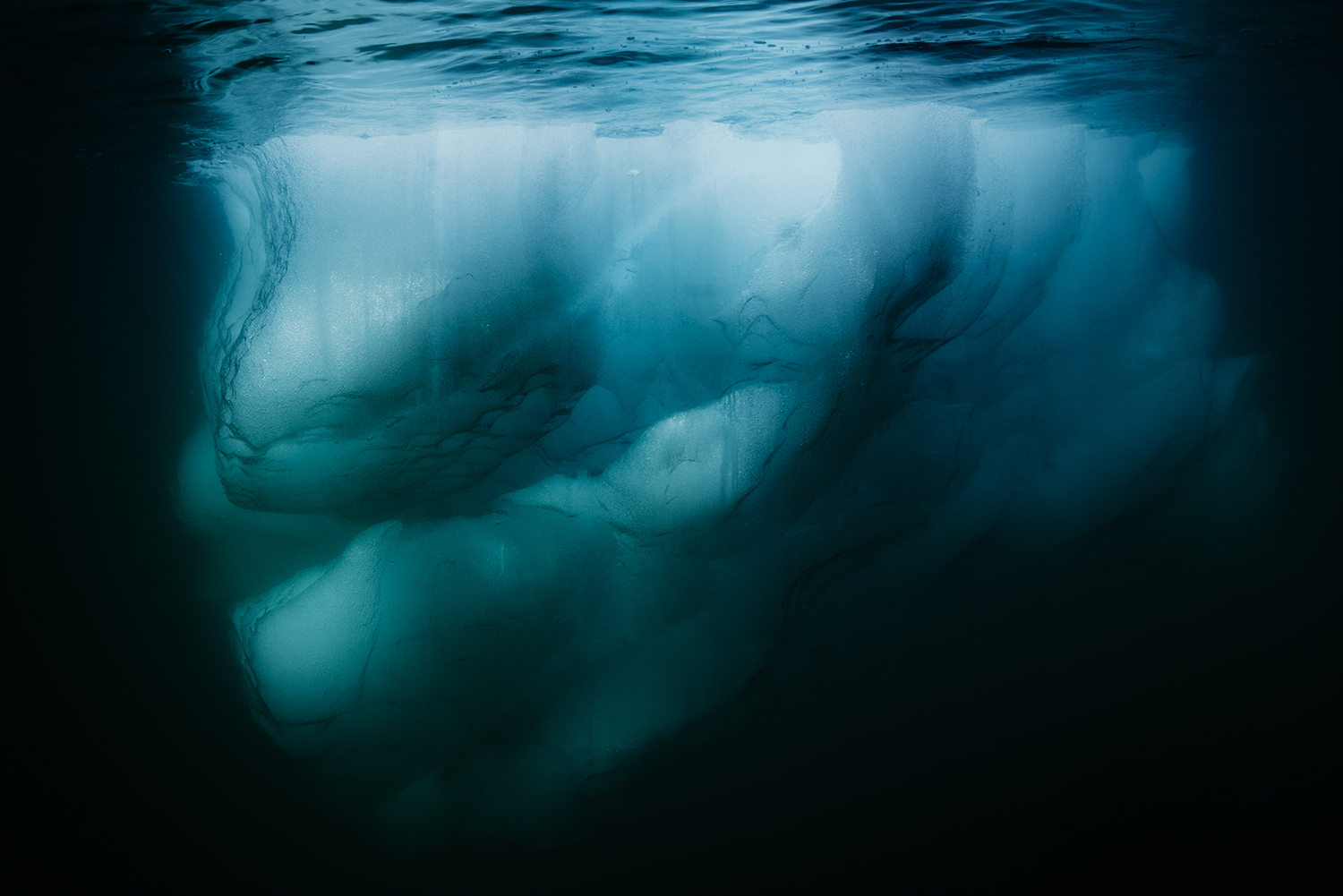 Underwater image of a iceberg Iceberg in Greenland. Positioned in the Arctic, Greenland is especially vulnerable to climate change and has experienced record melting in recent years and is likely to contribute substantially to sea level rise as well as to possible changes in ocean circulation in the future. Glaciers worldwide store about 75 percent of the worldâs fresh water and if all land ice melted, sea level would rise approximately 70 meters worldwide.