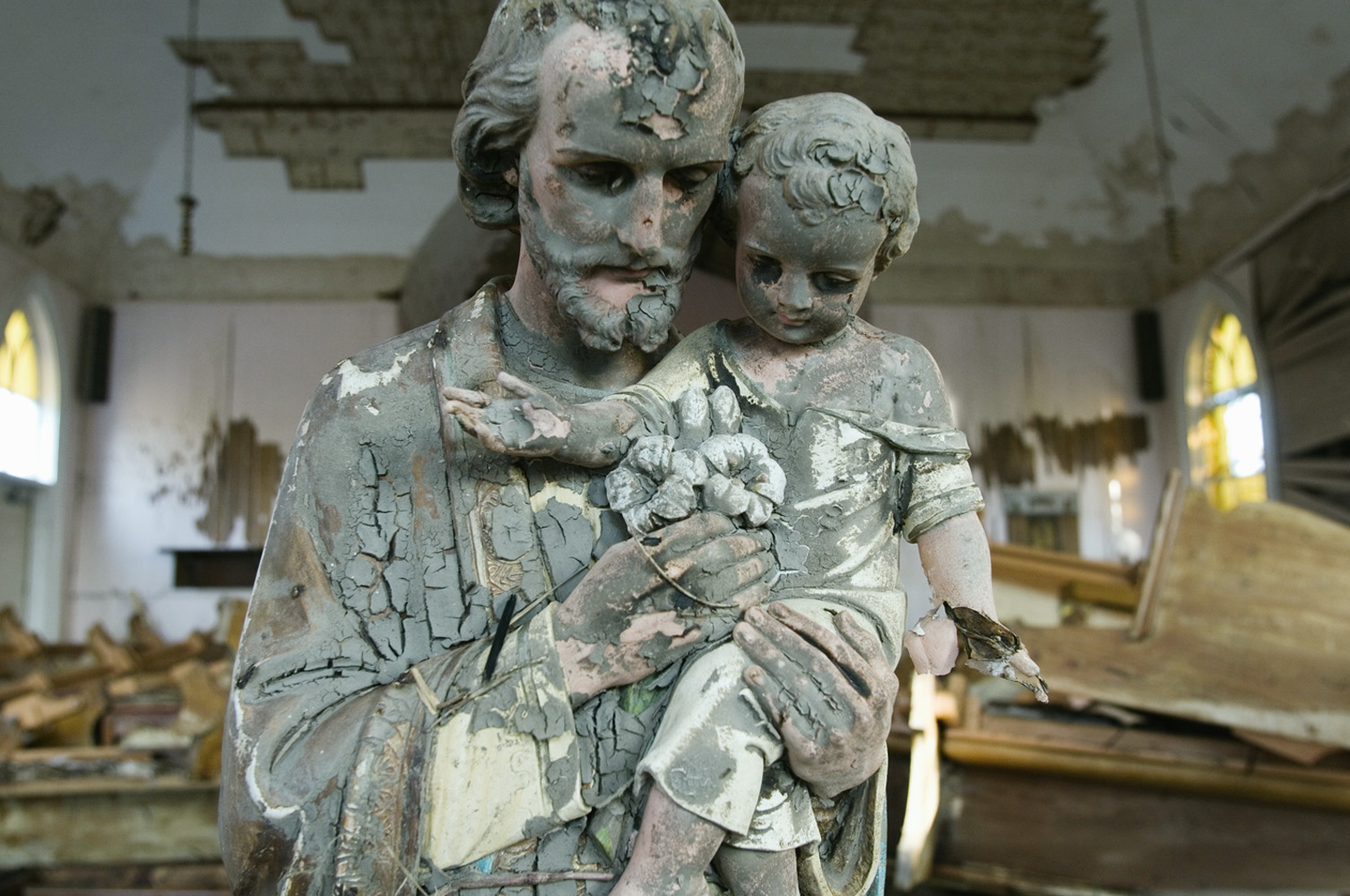 17 September 2005 Empire, Plaquemines Parish, Louisiana, USA.  Statue of Jesus covered with mud in the devastated Saint Ann Catholic church of Empire after the 33-foot storm surge accompanying Hurricane Katrina. The church has been lifted of itÂ´s foundations and moved.