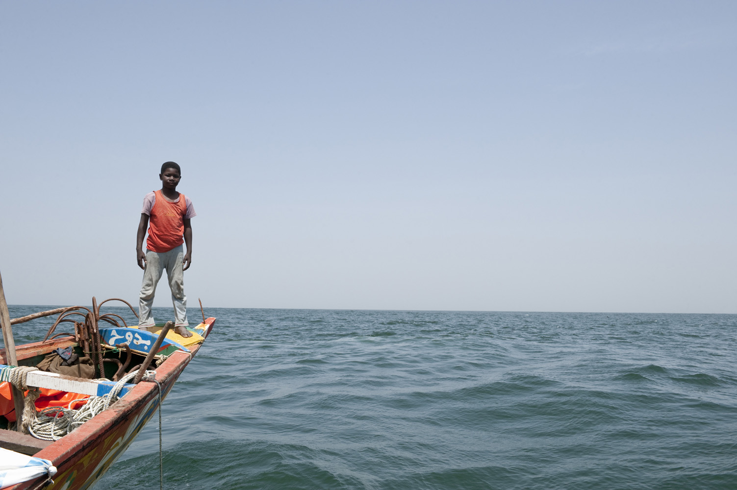 Atlantic Ocean, Senegal, 18 March  2010 Young boy on the Senegalese Pirogue fishing boat 'Sophie Fall' 46 nautical miles offshore, out fishing for 10 days.